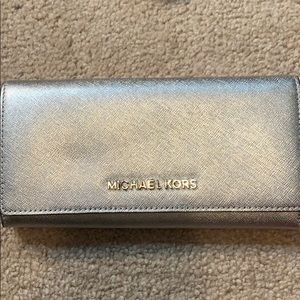 Get glitzy w this silver wallet from MK!